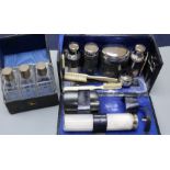 A set of three silver-mounted cut glass toilet bottles, cased and another cased toilet set with