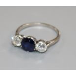 A platinum, sapphire and diamond three stone ring, size M.