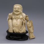 A carved ivory Buddha and a carved ivory deity