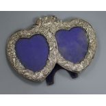 A late Victorian repousse silver mounted double heart shaped photograph frame, London, 1982, width