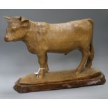 Lys. A carved wood figure of a cow height 36cm approx.