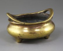 A Chinese bronze ding censer, Xuande mark but 18th/19th century, with a pair of high looped handles,