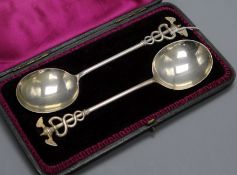 A cased pair of Victorian silver serving spoons with caduceus finials Aldwinckle & Slater, London,