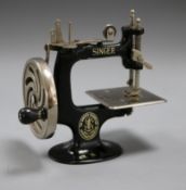 A child's toy Singer sewing machine by Dinger Manfg. Co