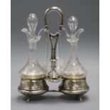 A pair of glass oil and vinegar bottles and stoppers in an Austro Hungarian white metal stand, 24.