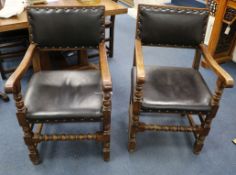 A set of eight oak and leather Cromwellian style dining chairs (six single, two arm)