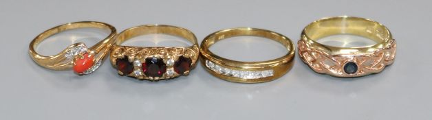 A Victorian style 9ct gold, garnet and diamond half-hoop ring and three other gem-set 9ct gold