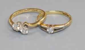 A 15ct gold and diamond solitaire ring and an 18ct two-stone diamond crossover ring