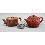 Two Yixing teapots, one with carved cinnabar lacquer decoration and a tea bowl