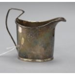 A George III silver cream jug, crested, of helmet form with strap handle (a.f.) London 1794, maker