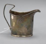 A George III silver cream jug, crested, of helmet form with strap handle (a.f.) London 1794, maker