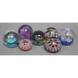 Three Strathearn millefiori glass paperweights, and four abstract glass paperweights by Caithness