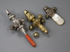 A 19th century silver and coral child's rattle and whistle and two other rattles.