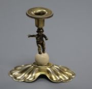 A continental gilt white metal and ivory set dwarf candlestick with figural stem, 10cm.