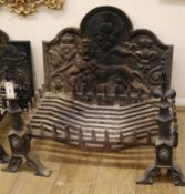 A cast iron fire-back, decorated with a lion rampant, together with a fire-back and fire dogs Basket