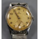 A gentleman's late 1940's stainless steel Omega manual wind wrist watch, on associated steel