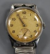 A gentleman's late 1940's stainless steel Omega manual wind wrist watch, on associated steel