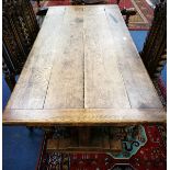 An oak refectory dining table with planked top W.153cm