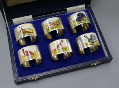 A modern cased set of six silver and enamel 'game bird' napkin rings, W.I. Broadway & Co,