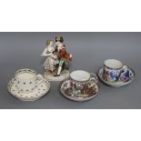 A small collection of cabinet porcelain, including a Meissen group of a dancing couple, possibly