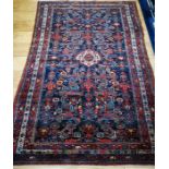 A Shivan red and blue rug with geometric motifs 205 x 135cm