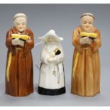 A pair of Royal Worcester candle extinguishers of a monk and one of a nun