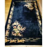 A Chinese midnight blue ground floral embossed rug 240 x 150cm