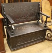 A Victorian carved oak box seat settle W.108cm