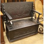 A Victorian carved oak box seat settle W.108cm