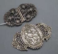 Two white metal belt buckles, largest 12cm.