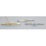 Two early 20th century 15ct gold and gem set bar brooches and a yellow metal, blue zircon and