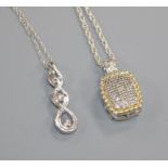 Two silver and diamond set pendants on chains.