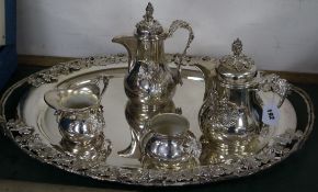 A plated tray and a four piece coffee set