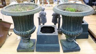 A pair of painted cast iron campana-shaped urns on stands overall height 67cm