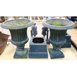 A pair of painted cast iron campana-shaped urns on stands overall height 67cm