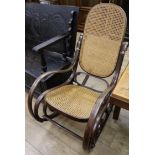 A stained beech bentwood rocking chair, with caned seat and back