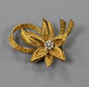 An 18ct gold and diamond set flower brooch, 45mm, gross 16.8 grams.