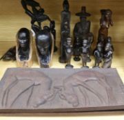 A group of African carvings and two wood plaques