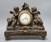 A French bronzed plaster mantel clock, decorated with cherubs height 33cm