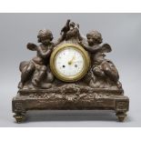 A French bronzed plaster mantel clock, decorated with cherubs height 33cm