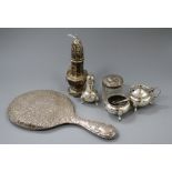 A silver sugar castor, three silver condiments, a toilet jar and three spoons.