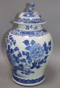 A Chinese blue and white painted lidded baluster vase, painted with blossoming peonies height