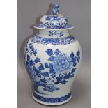 A Chinese blue and white painted lidded baluster vase, painted with blossoming peonies height