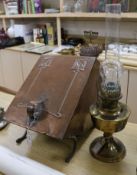 An Arts & Crafts planished copper coal scuttle and a brass oil lamp