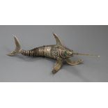 A Spanish white metal articulated free-standing model of a swordfish with green cabochon stone eyes,