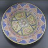 A large geometric design polychrome painted charger diameter 48.5cm