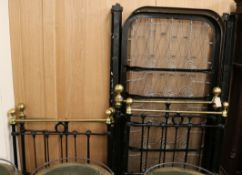 A pair of black and brass single beds W.77cm