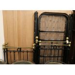 A pair of black and brass single beds W.77cm