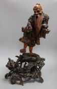 A 19th century Chinese figural rootwood carving of an immortal height 60cm