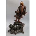 A 19th century Chinese figural rootwood carving of an immortal height 60cm